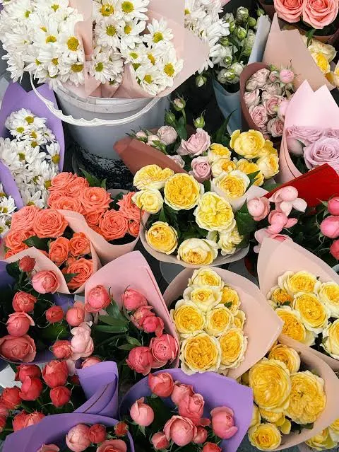 Shelves of colourful wrapped bouquets in a flower shop